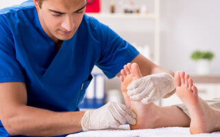 Podiatrist treating feet during procedure
