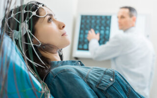 Charming young woman undergoing electroencephalography